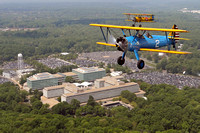 Justin Currier piloting Stearman 02 near CIA HQ on the run in down the Potomac River inbound for the DC Mall-Copyright David F Brown